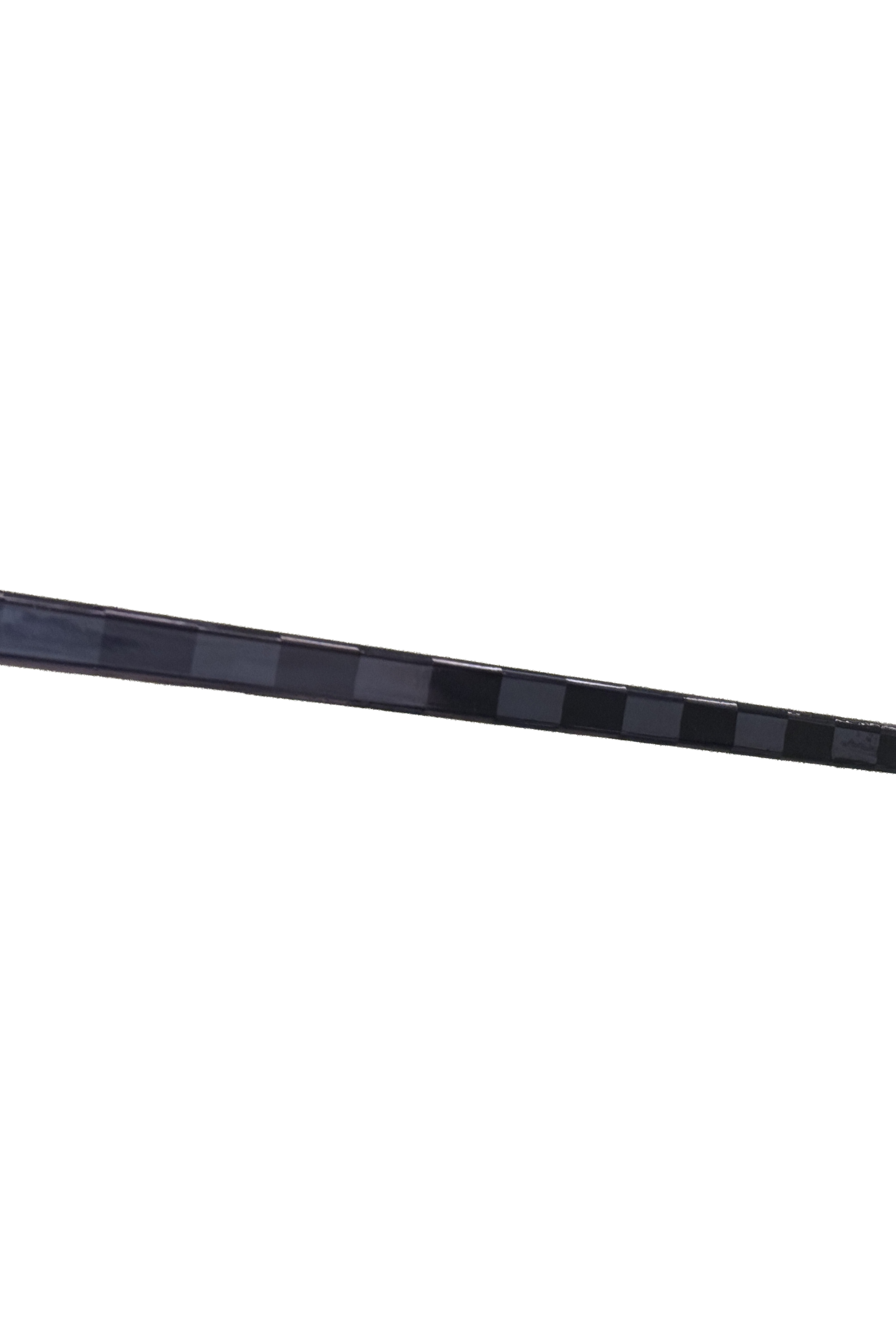 Close-up of HKY IQ 24K hockey stick blade with checkered carbon fiber weave pattern